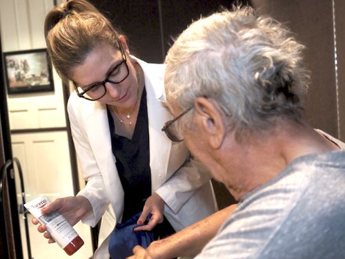 Dr. Kate Viola helping a veteran with a free skin exam